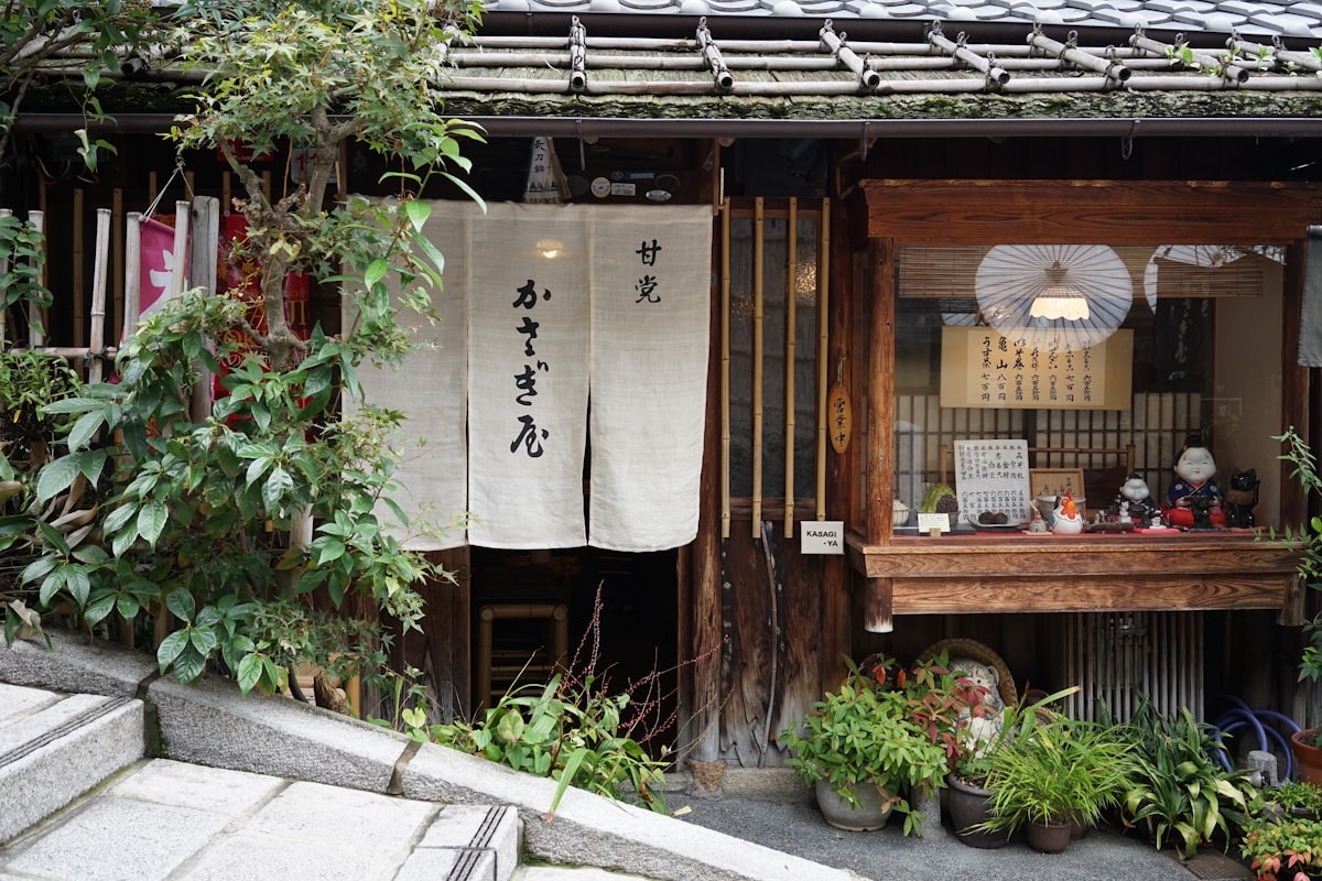 Una casa tradizionale di Kyoto con il noren all'ingresso e le piante davanti