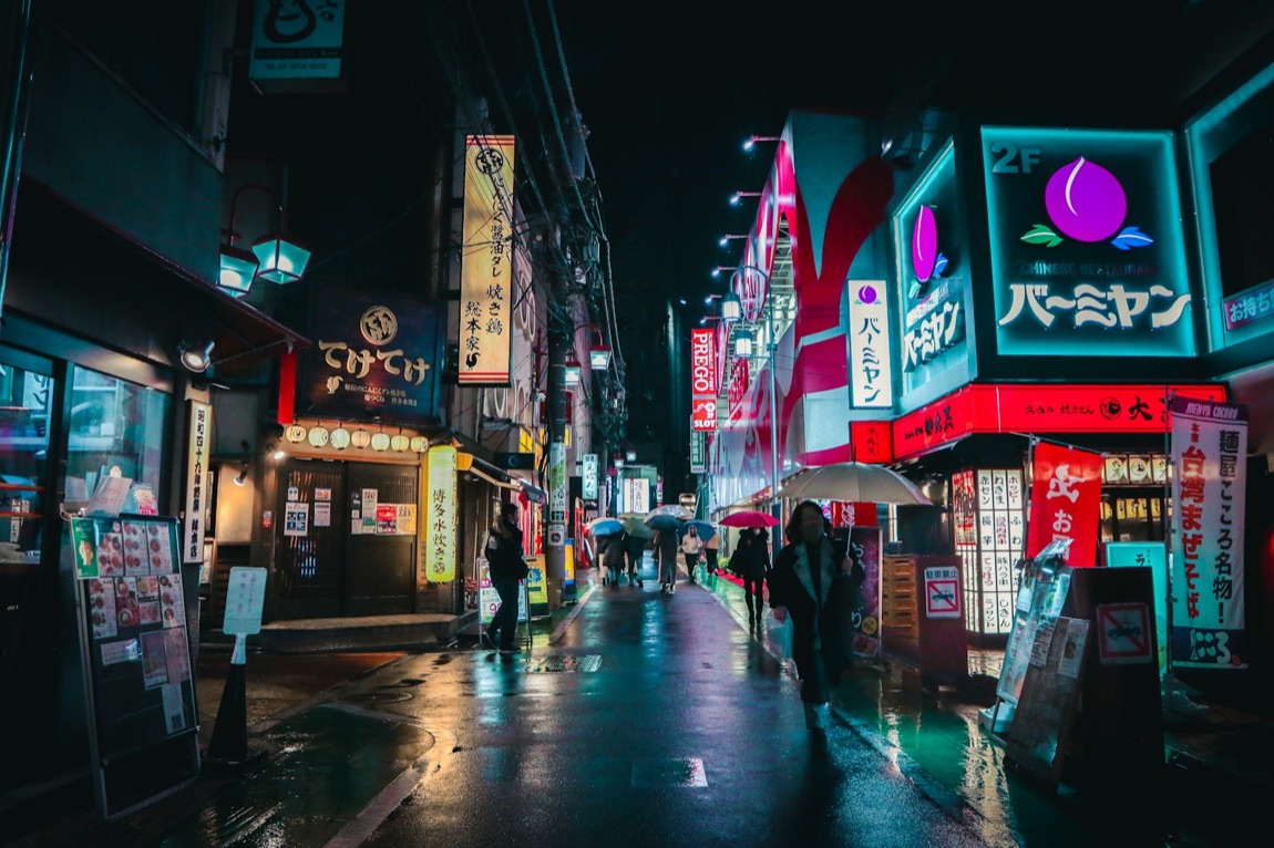 Un vicolo di izakaya di Tokyo la sera, con le lanterne e le insegne illuminate